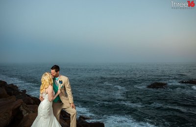 Bride and Groom share a kiss behind the Ocean Institute overlooking the Pacific Ocean