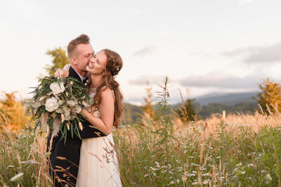 Photo of bride and groom hugging after getting married outside of Asheville