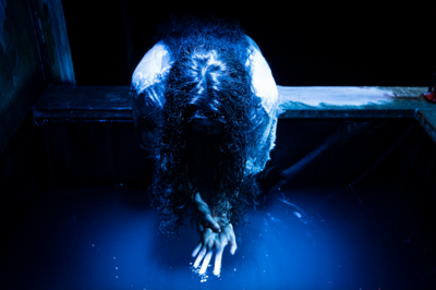 Woman washing hands over a fountain