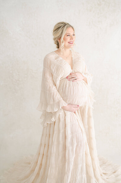 pregnant lady wearing needle and thread smocked gown