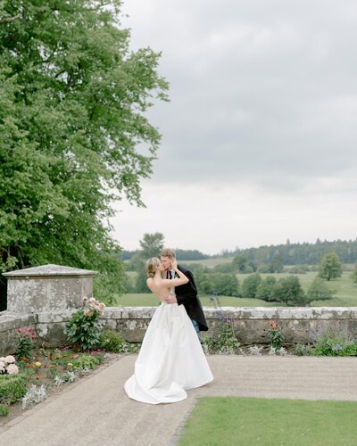 Bride and Groom kiss in the grounds of Blairquhan Castle on their private estate wedding in Scotland, planned by one of the UK's best wedding planners, Laura McCranor Events. Image by multi-award winning luxury wedding photographer uk, Jill Cherry Porter.