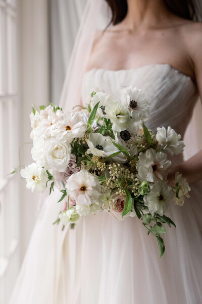 All white bridal bouquet with hand tied flowers