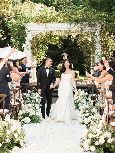 Bride and groom pose for photo at their wedding reception