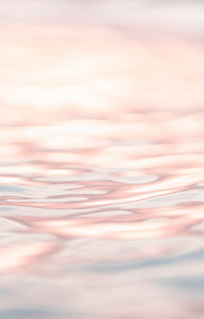 Close up of water surface. Pink coloured