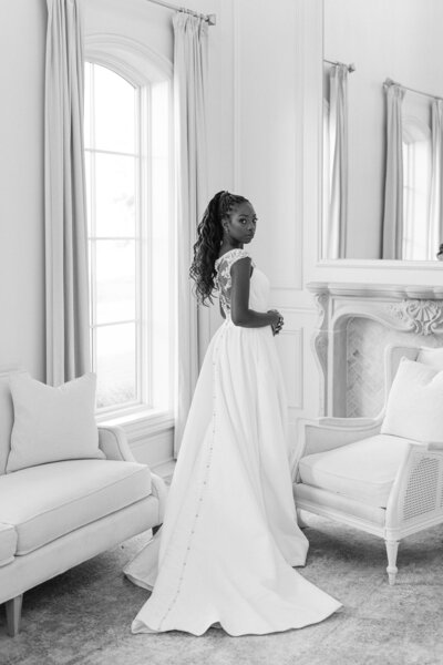 a woman wearing a wedding dress in a bridal suite