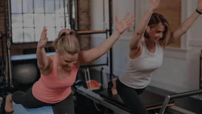 woman demonstrating a lunge in a pilates class 