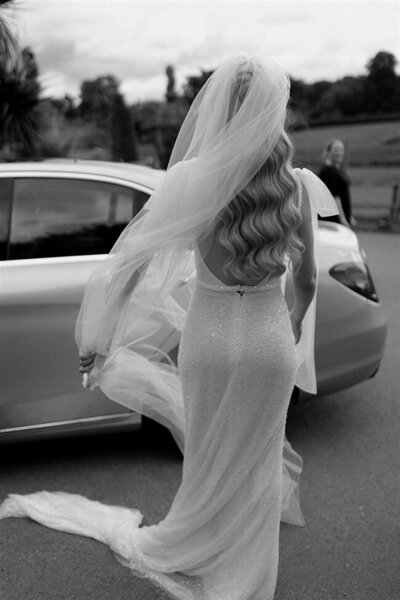 Real Bride Bethany's Modern, Hollywood wave half up half down hairstyle with veil for her wedding at Burley Manor