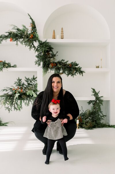 mom and daughter on baby's first christmas.