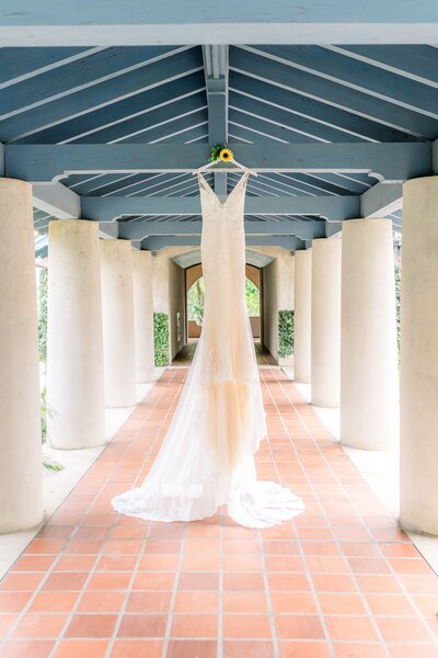 Wedding dress hangs from walkway