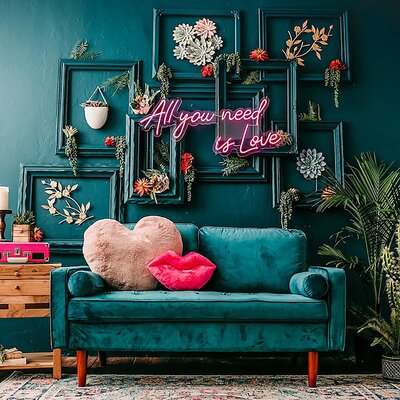 Teal Couch with teal wall behind it, pink Neon sign over couch