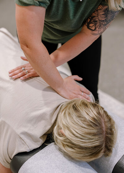 Chiropractor Brittany Fisk adjusting a patient’s neck during a gentle chiropractic session at Busy Bee Chiropractic.