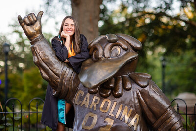 A University of South Carolina student taking her senior portraits on campus by the Cocky Statue