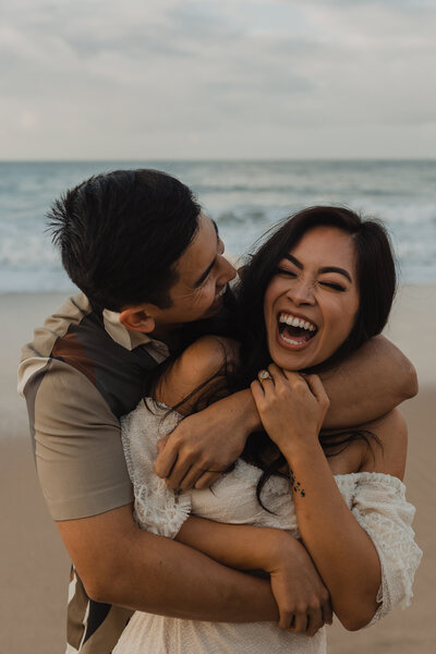 A couple kisses on the coast of California during their elopement