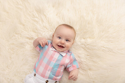 blue eyed baby boy in plaid shirt by Milestone Photographer New Philadelphia