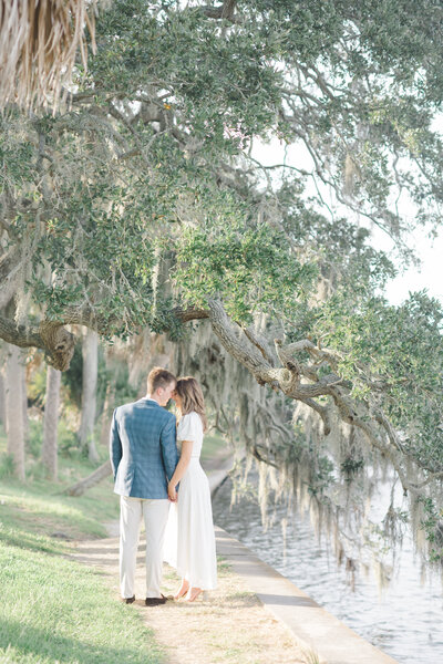 bride and groom standing by a hanging moss tree