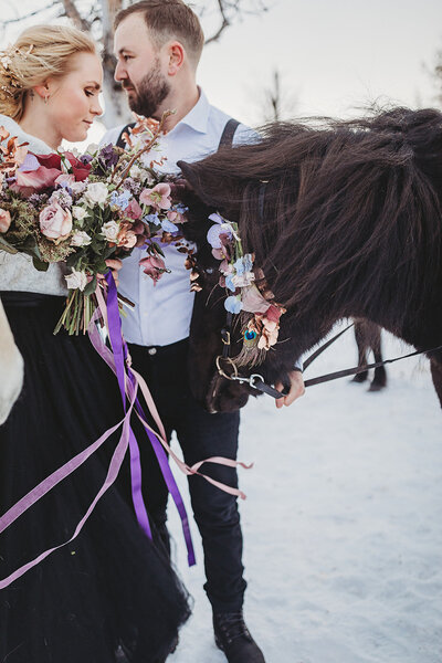 Award-winning photographer Rebecca Lundh photographs newlyweds with their horse in the Swedish Arctic