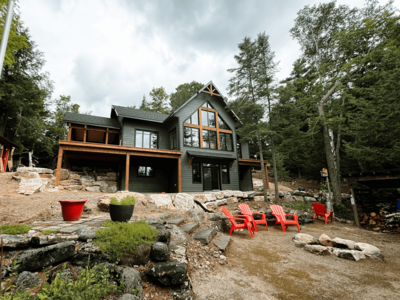 Timber-framed custom lakehouse in Haliburton Highlands designed for modern living with rustic charm and natural finishes.