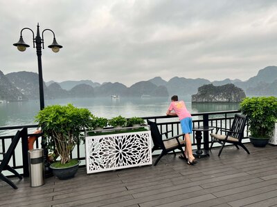 Meghan and daughter looking out at a misty bay with karst formations — expat parenting experiences