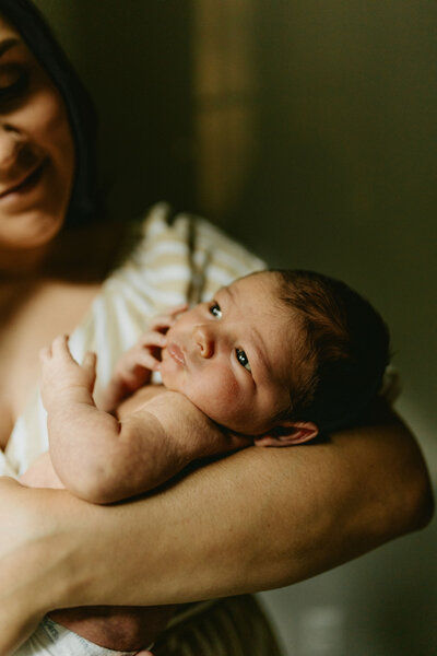 up close portrait of a mother holding her newborn