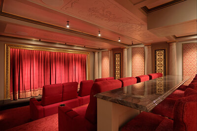 Home theatre with red carpet, curtains and chairs
