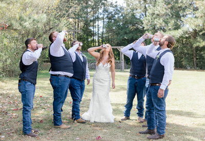 bride with groomsmen sharing a beer
