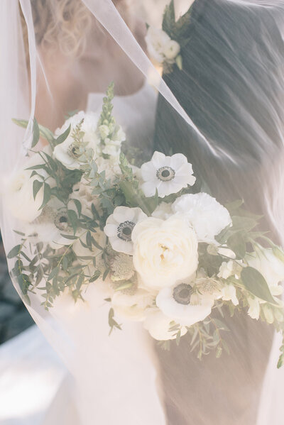 Bride and groom with white floral bouquet designed by Abby Grace Florals at Saluda SC wedding
