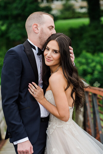 bride and groom embracing on dock
