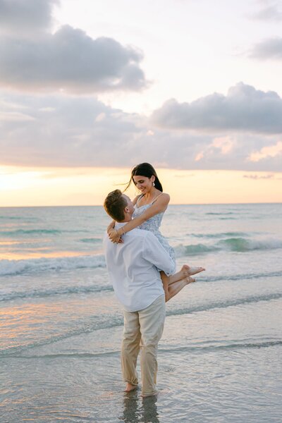 couple pose on beach at florida engagement shoot
