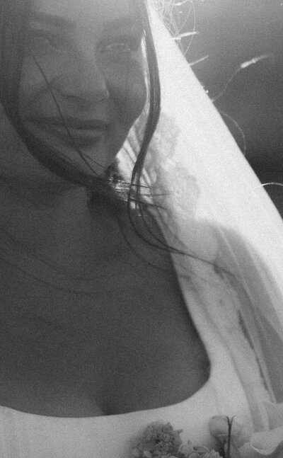 Documentary wedding photography of bride smiling at her groom