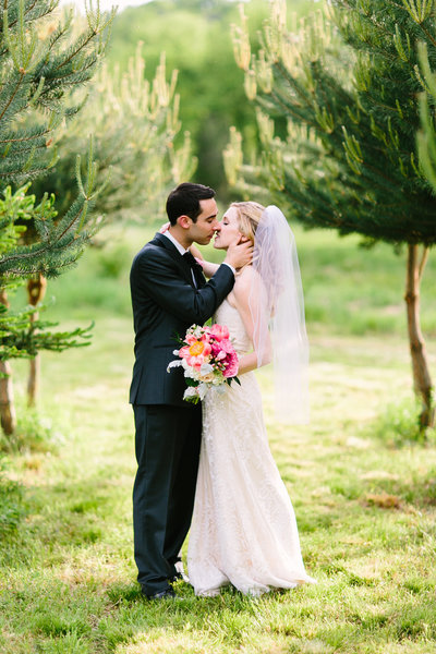 Bride and groom kissing at Blooming Hill Farm Wedding