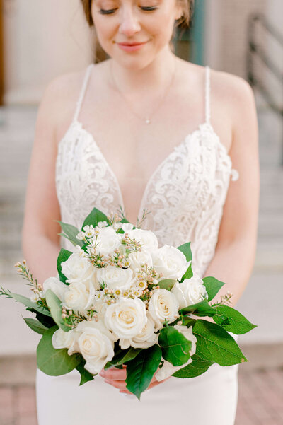 Bride holding flowers by Rachael Mattio Photography