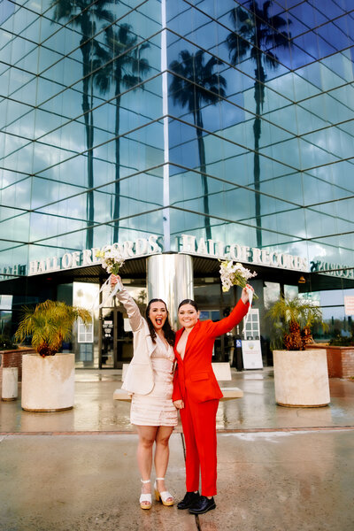 couple standing in front of courthouse after getting married