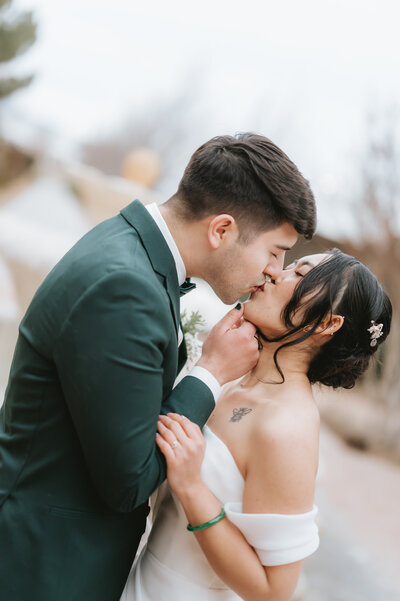 Groom kissing bride at luxury wedding venue in New Mexico