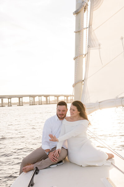 Orlando couples photographer captures sweet couple admiring their ring at sunset on a sailboat!