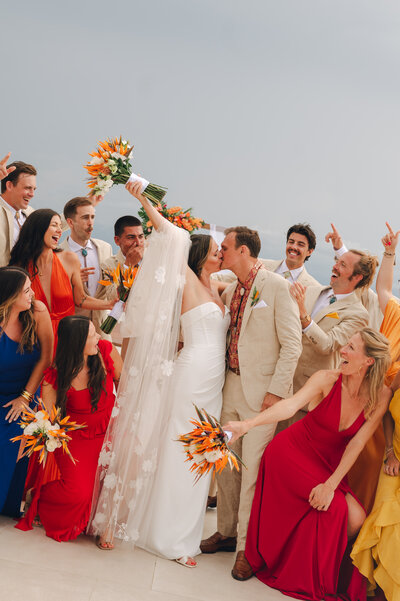 Bridesmaids help bride with her wedding dress