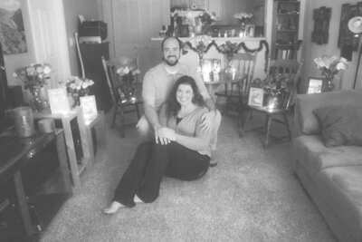 Hope and her husband in their living room at Christmas time.