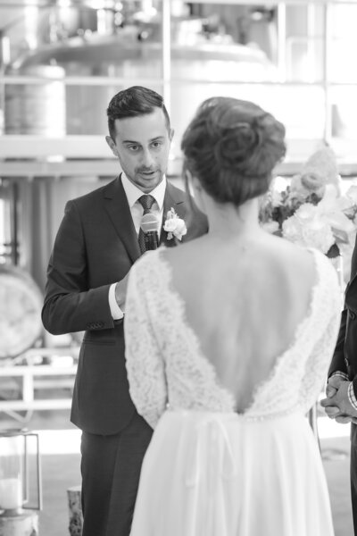photo of bride looking at groom during speeches on wedding day