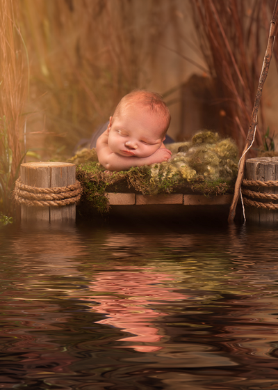 Rustic dock-inspired newborn photography session with soft lighting in Gardner, Kansas. Captures peaceful moments for families seeking milestone photography.