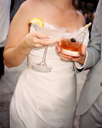 A look at a bride and groom's drinks in their hands