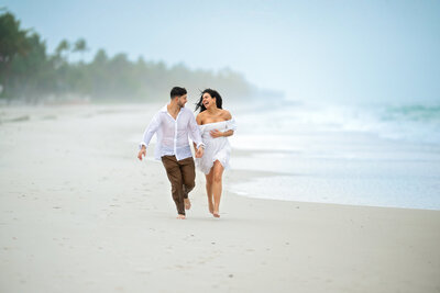 Indian couple in love having piggy  back ride by Lake Michigan surrounded by tall  skyscrapers