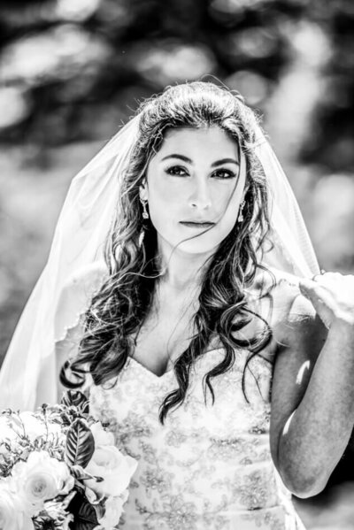 bridal portrait in black and white in downtown cleveland with hair blowing in wind