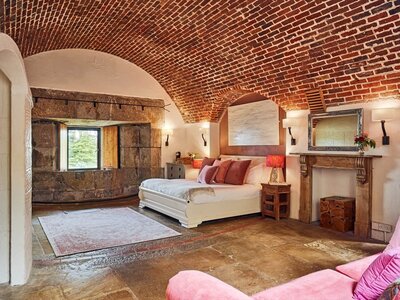 A beautiful rustic bedroom with stone floors