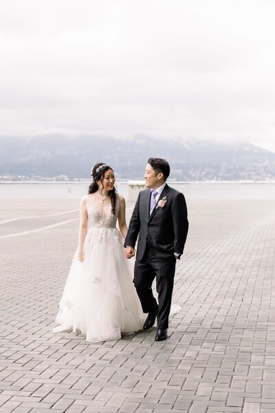 Bride and groom on a balcony outside in vancouver, canada