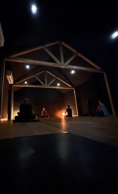 Meditation in dark beautiful yoga studio