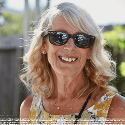 Smiling photo of Kristi in a yard