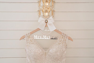 Elegant wedding dress displayed on a personalized hanger, ready for a luxury wedding in Raleigh, NC.