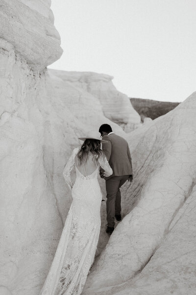 Bride and groom exploring canyon