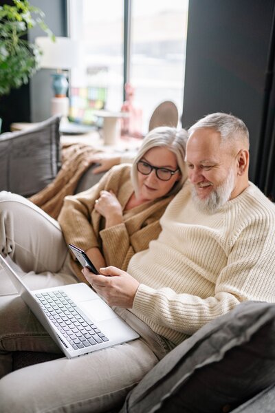 Couple planning their retirement from Laptop on the Couch