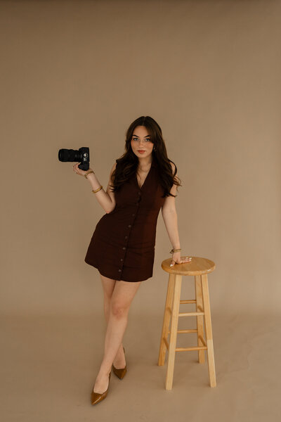 Behind-the-scenes branding image of Abby Dutra, a Cincinnati wedding photographer, setting up a studio shot.