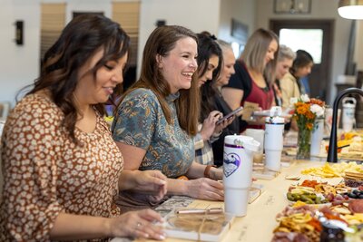 woman at table laughing at a joke